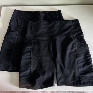 Two pair of Fabletics Powerhold biker shorts with pockets